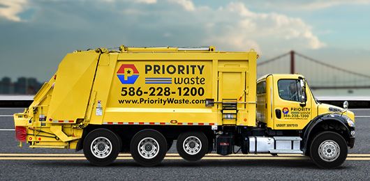A yellow priority waste truck.