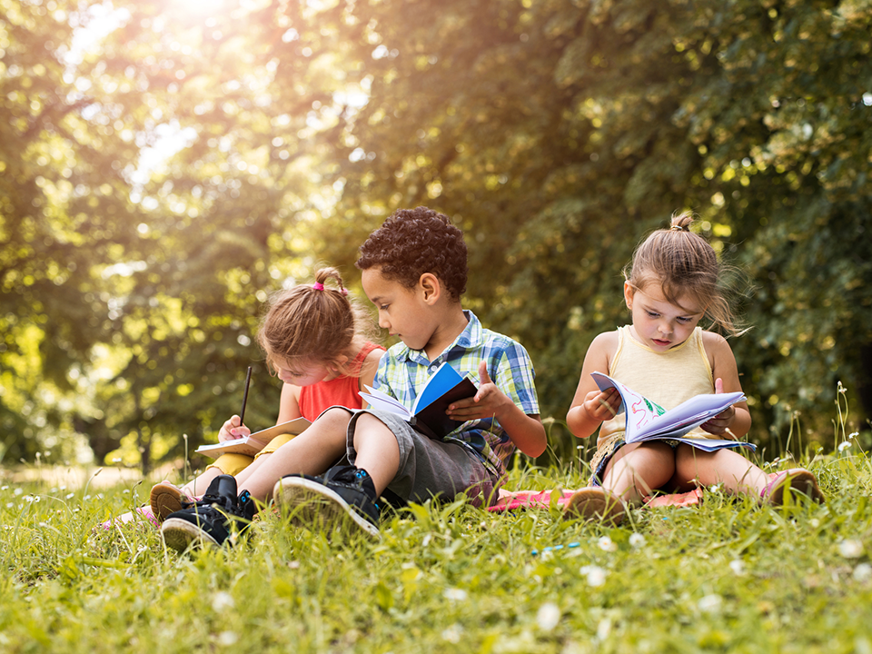 Children reading in the grass